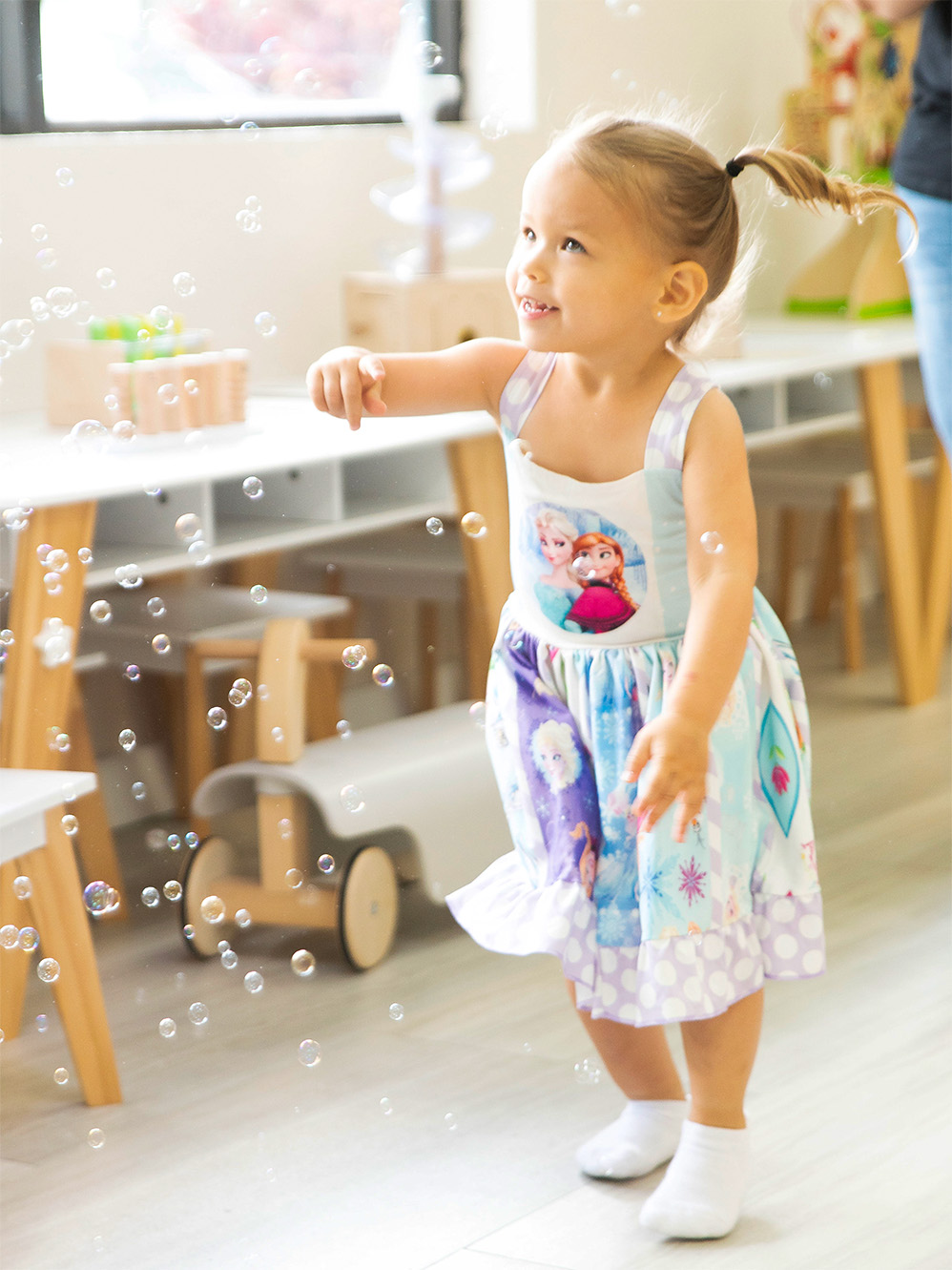 Young girl, playing with bubbles at Softopolis